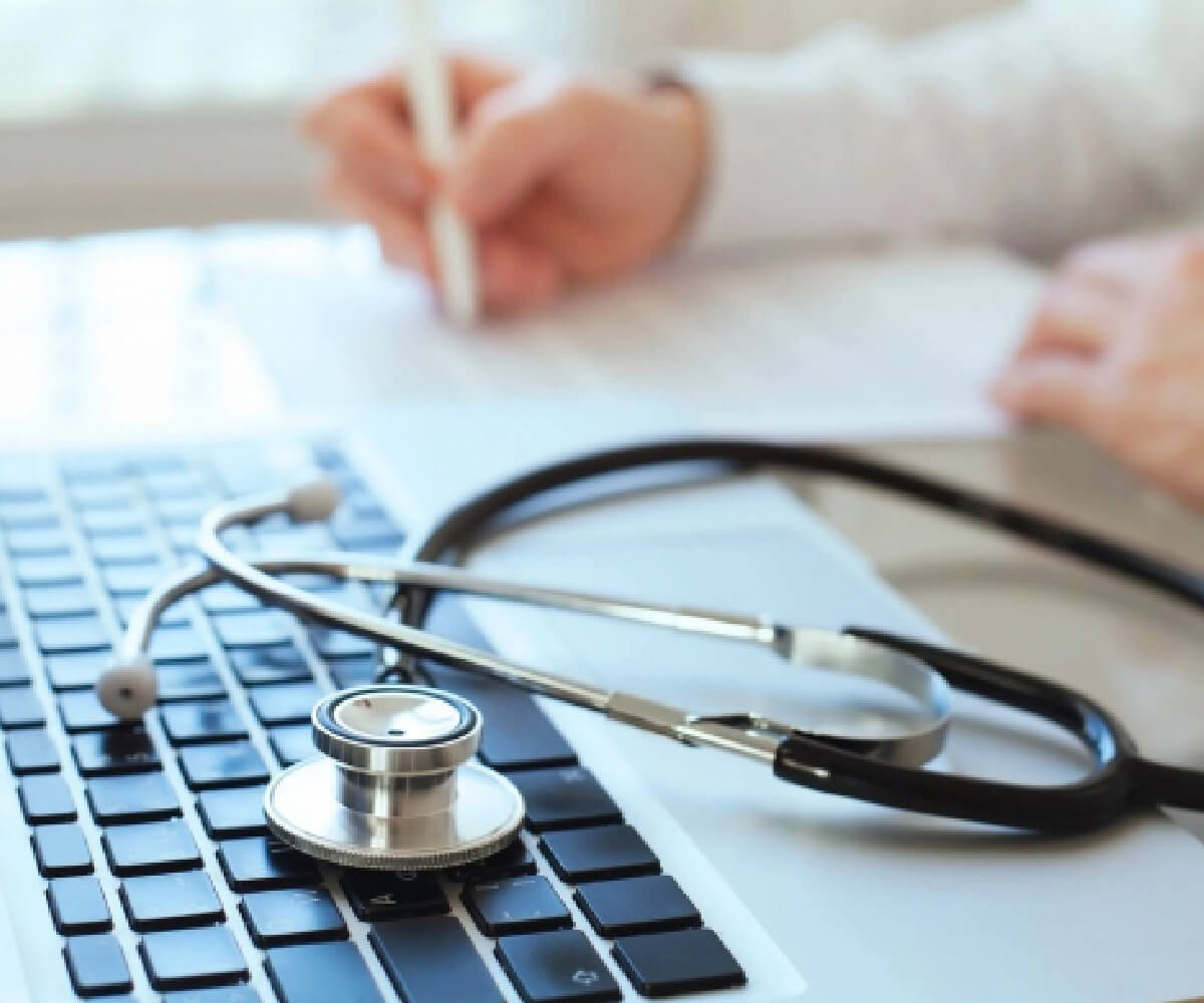 A stethoscope sitting on top of a keyboard.